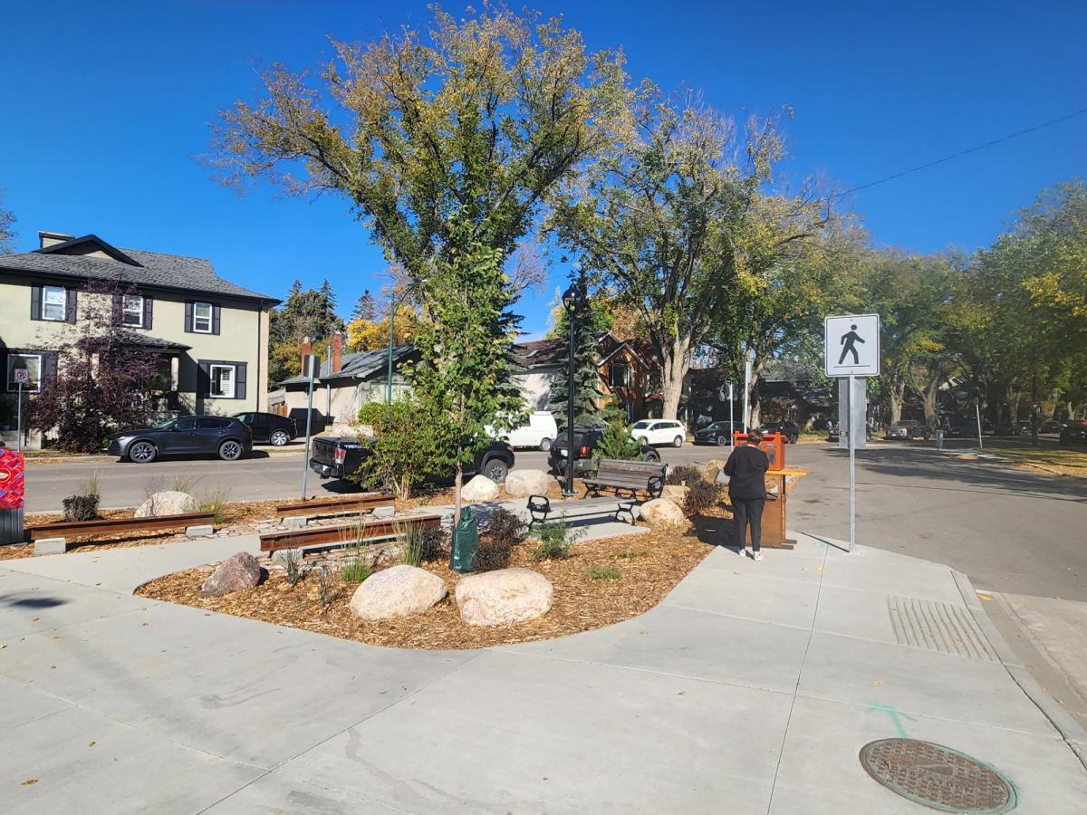 Image showing 14th Street parklet after construction during the day. The parklet feature decorative heritage rails, new concrete walkway, plantings, benches, bike racks, and lighting.