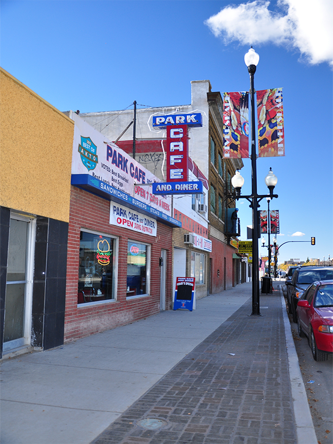 20th Street west street after construction. Image highlights a rejuvenated public realm with new unit pavers and street furniture.