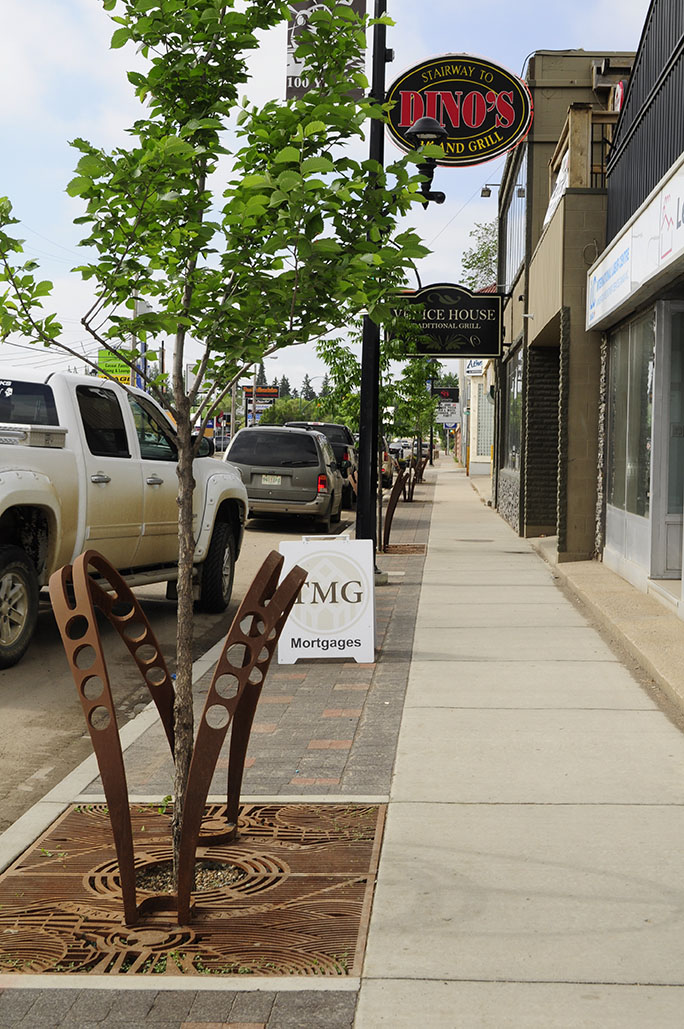 Image showing Central Avenue after streetscape after construction. Image highlights new street furniture, unit pavers, and trees.