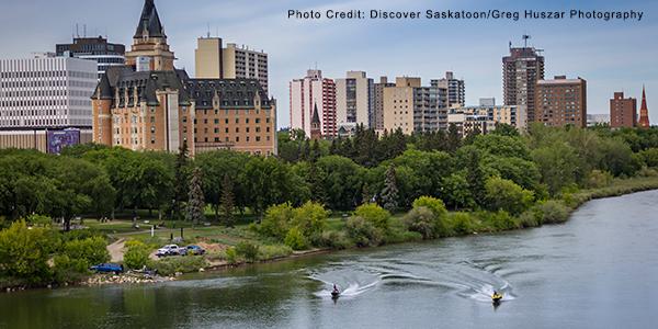 Downtown Saskatoon with residents enjoying the river