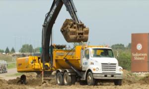 Backhoe lifting dirt